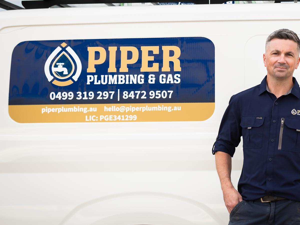 Craig MacDonald standing beside the Piper Plumbing & Gas van