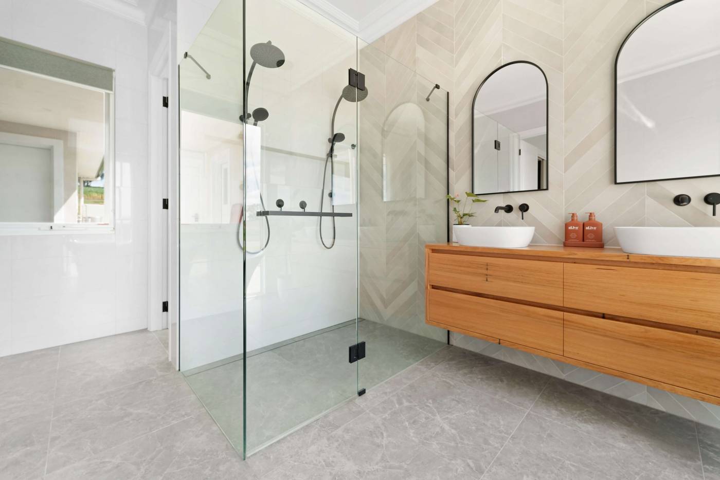 Ensuite with a walk-in shower, twin basins and a timber vanity